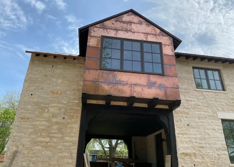 Copper metal panel facade on a stone building for Skylight Installation in Urbana