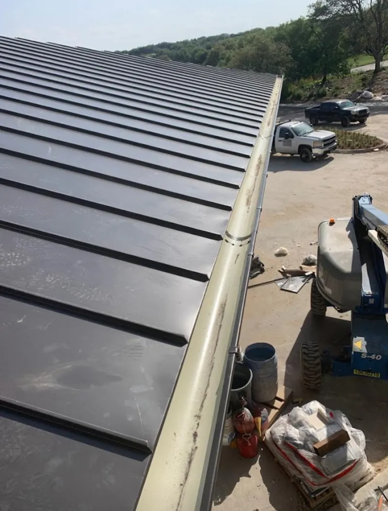 Standing seam panel and gutter detail on a metal roofing jobsite in Urbana